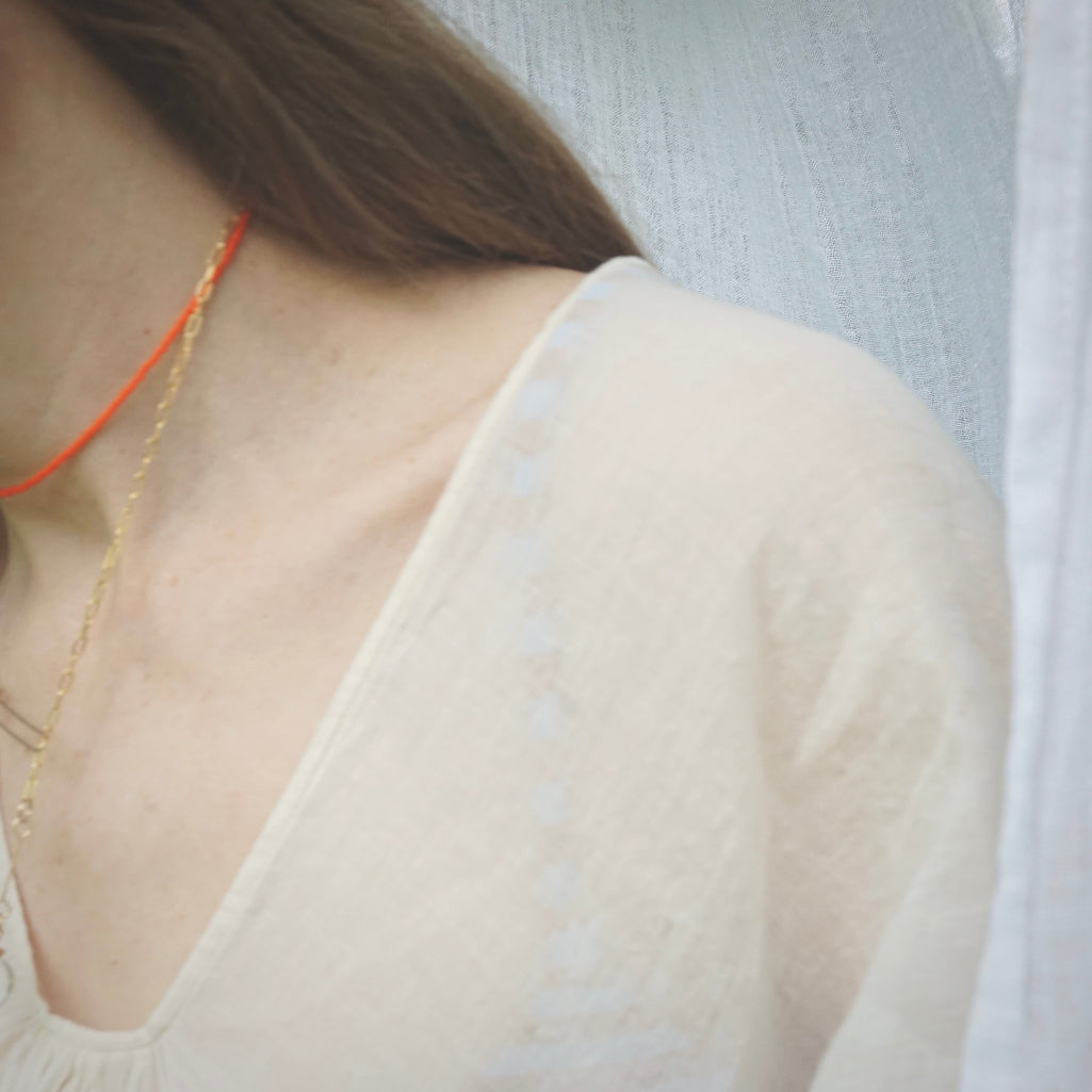 model wearing beaded orange choker