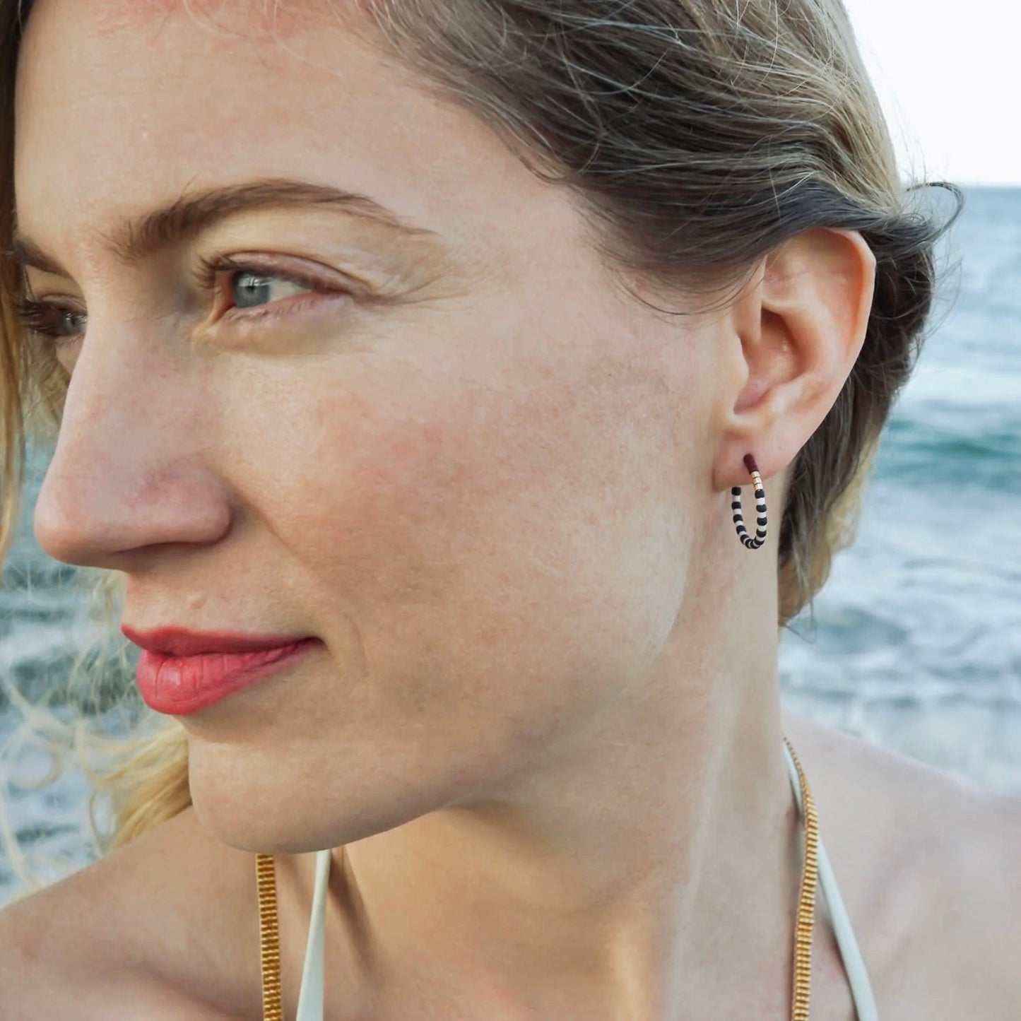 model wearing small striped hoops