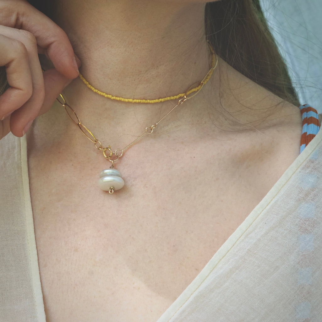 model wearing beaded yellow choker