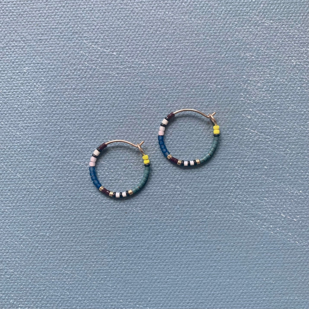 small beaded hoop earrings in blue and green multi