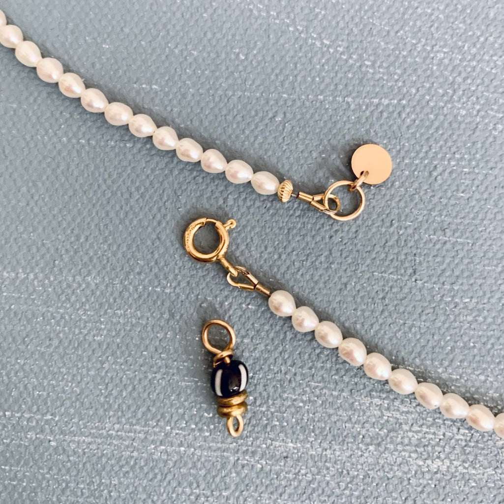 two charms on beaded pearl necklace