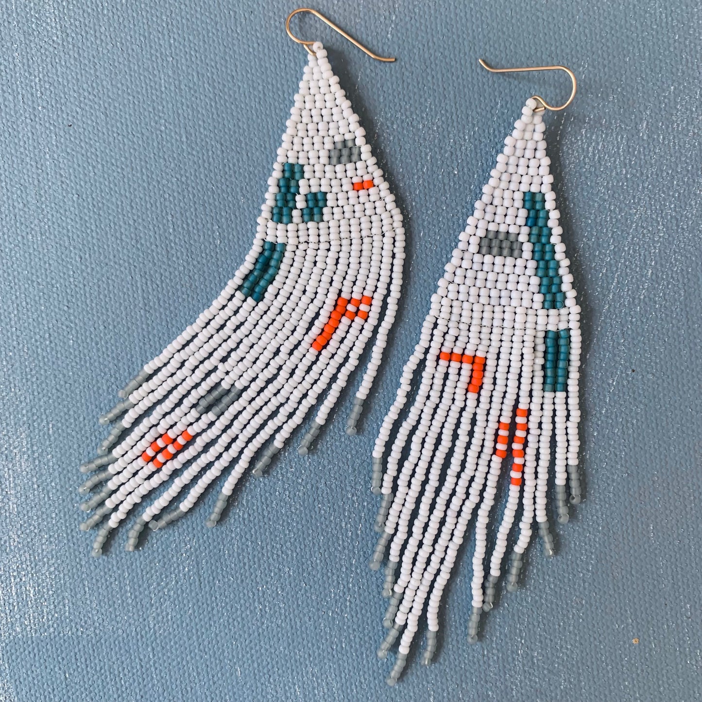 feather earrings in baby blue