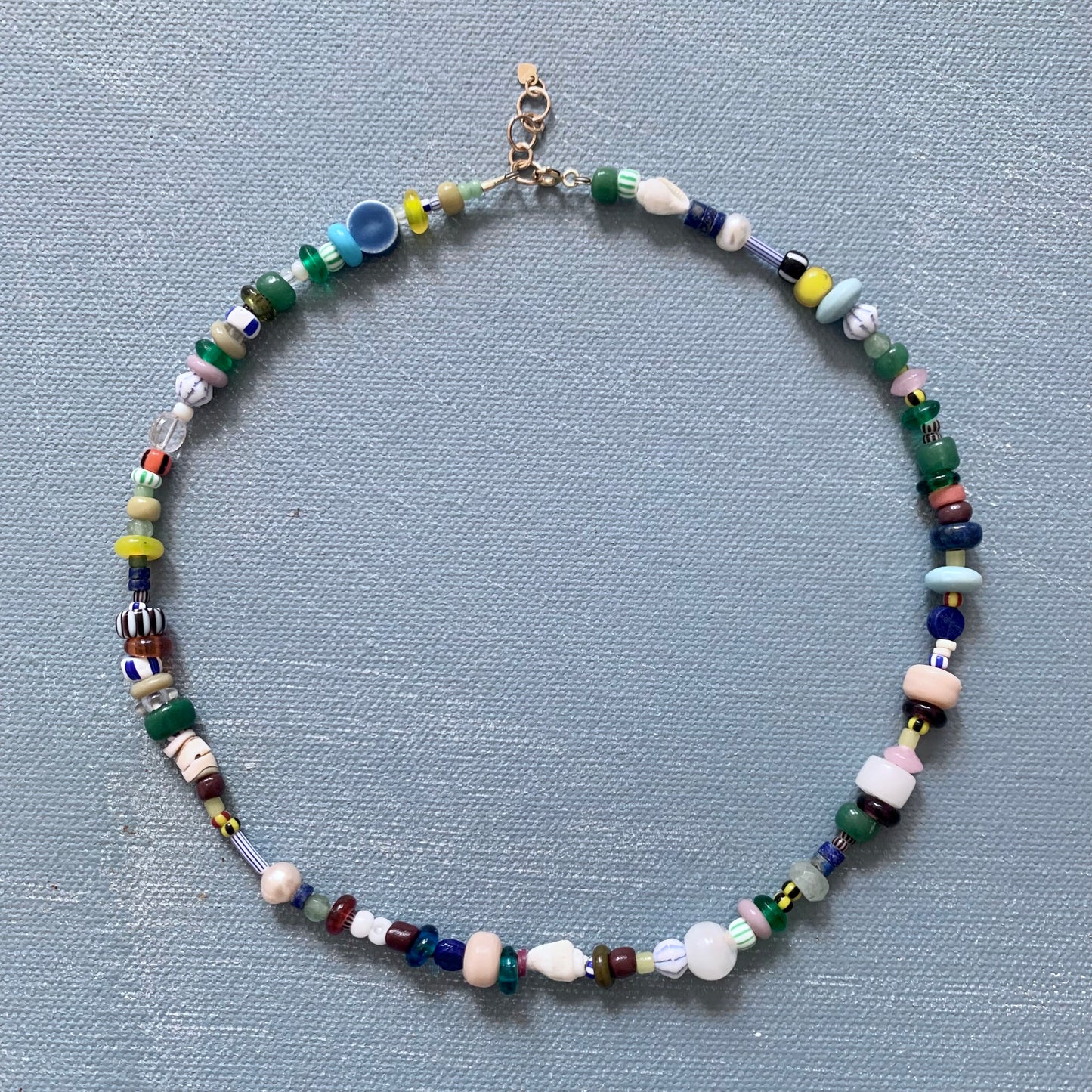 chunky beaded necklace shown on blue background