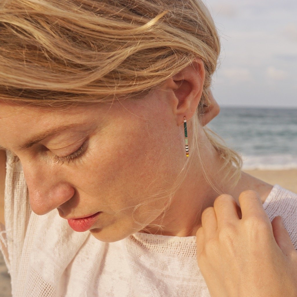 model wears large beaded staple earring