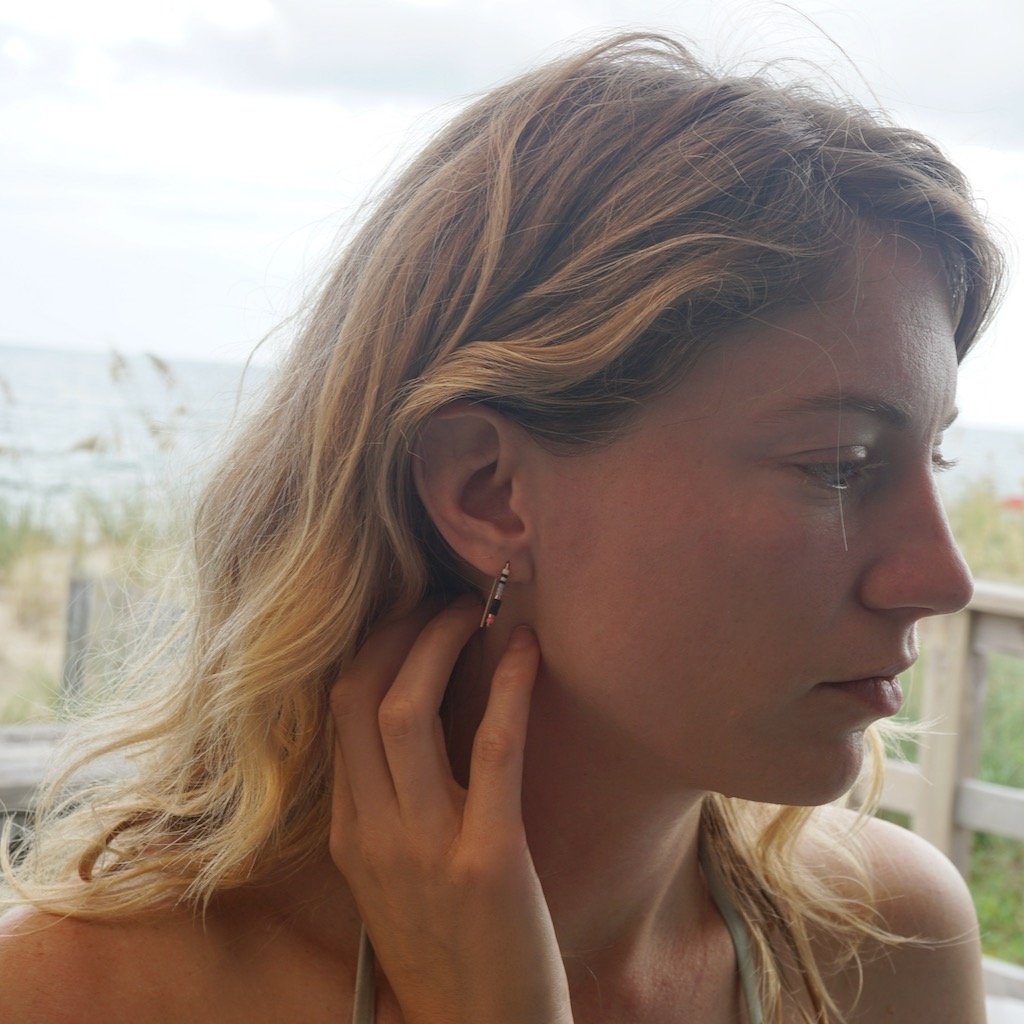 model wears small beaded staple earrings