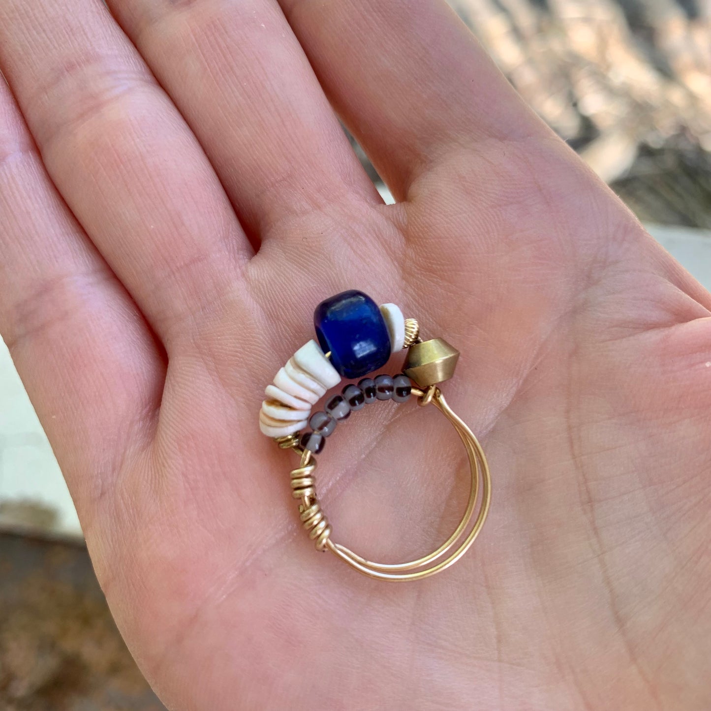 blue beaded ring held in hand