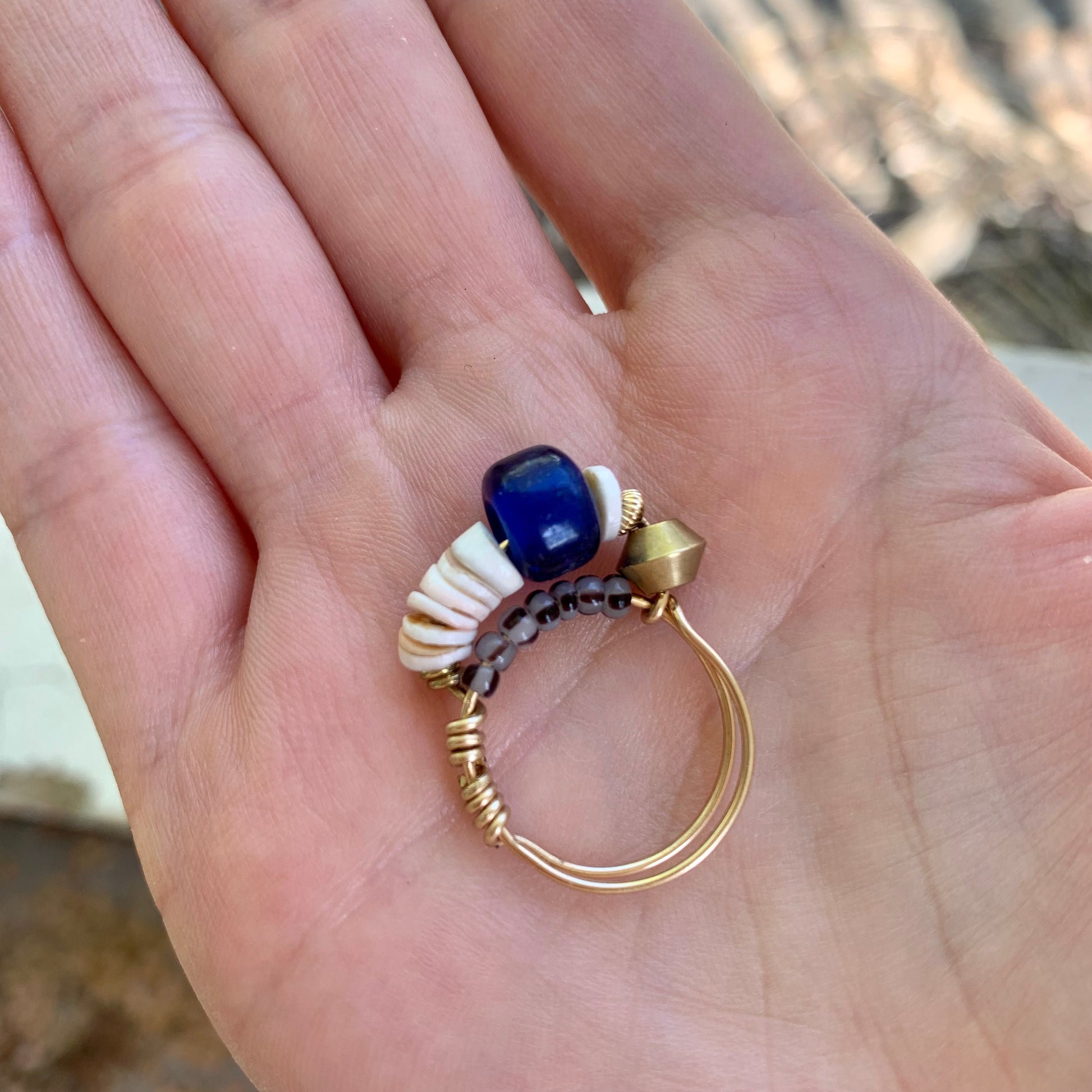 blue beaded ring held in hand