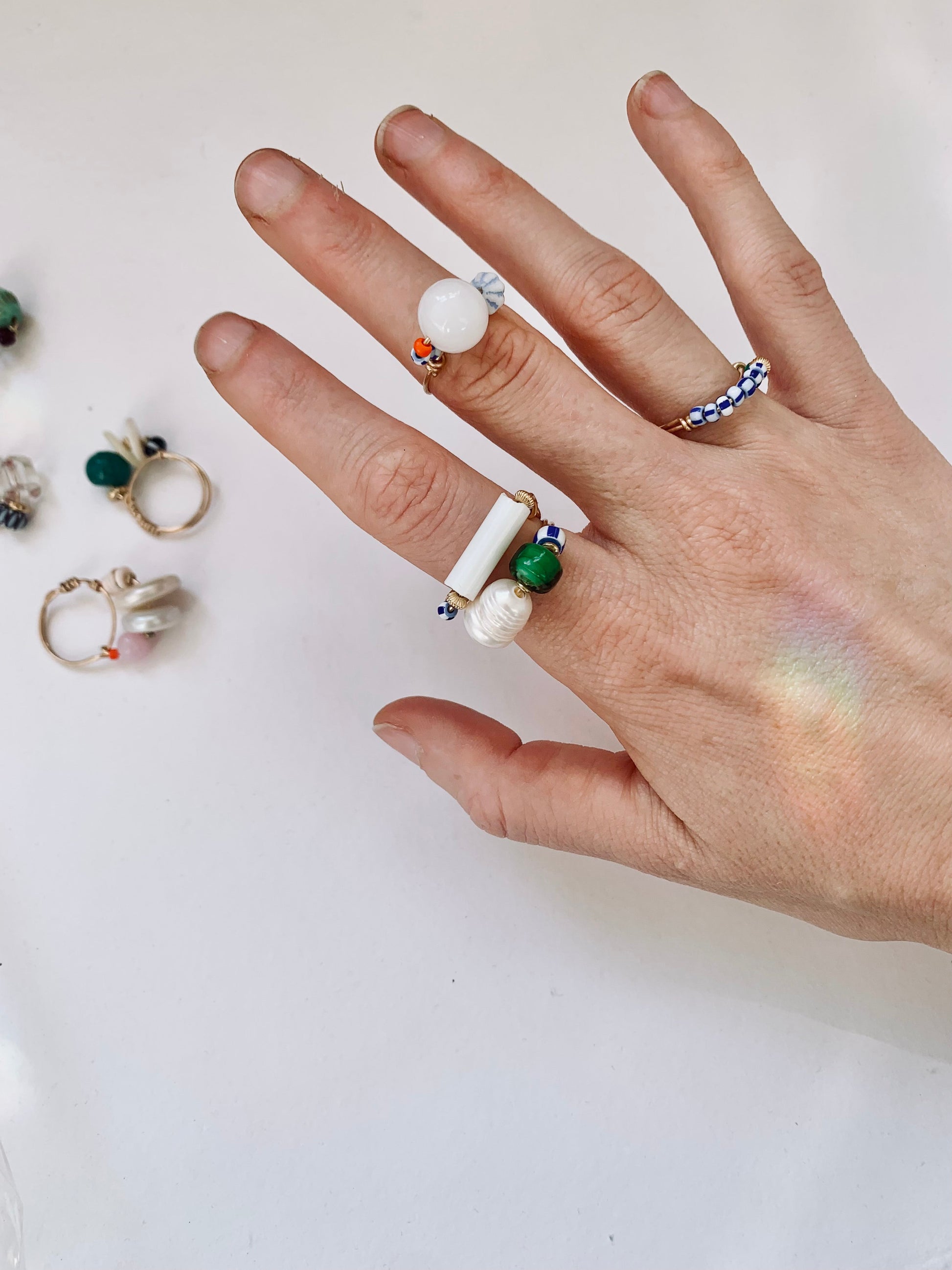 model wears assorted beaded rings